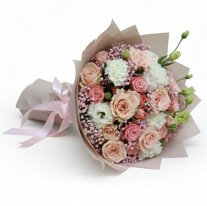 A bouquet of roses and other flowers in soft pink tones