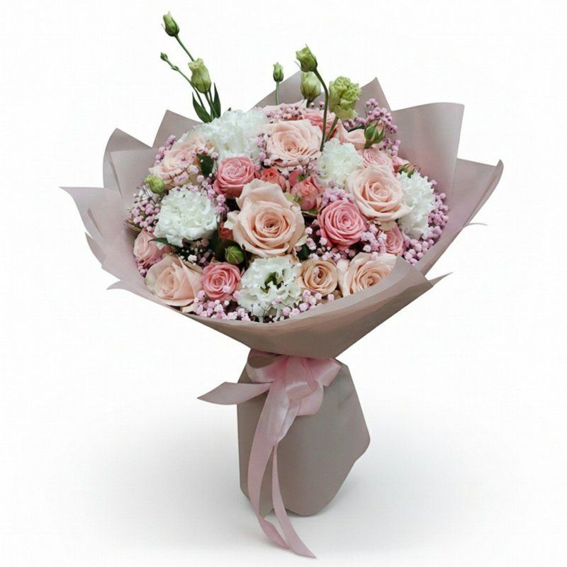 A bouquet of roses and other flowers in soft pink tones