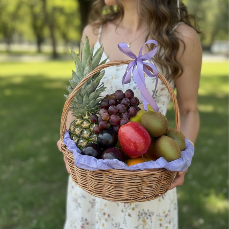 Fruit basket with pineapple, kiwi, and grapes